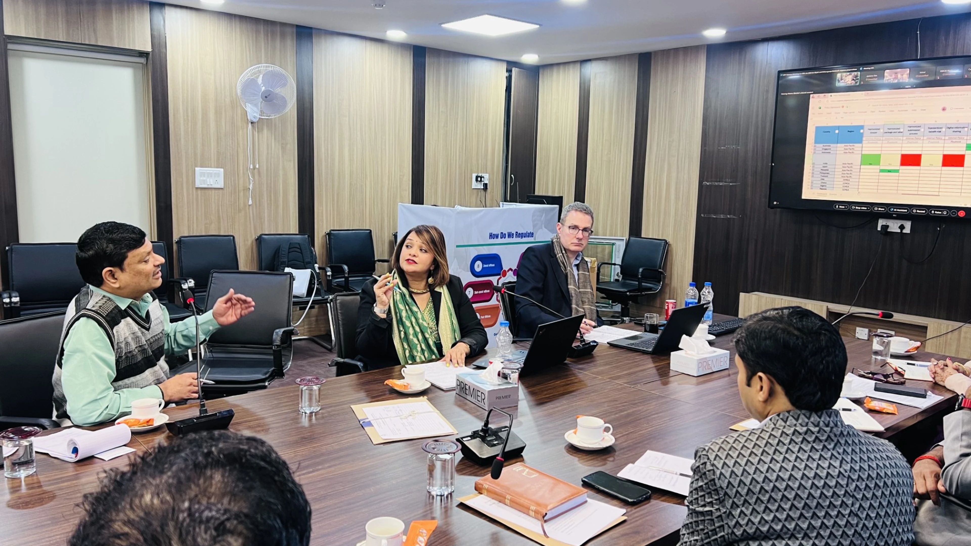 Regulators gather in a room to discuss 100 Day Mission readiness 